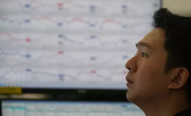 A dealer watches computer monitors at a dealing room of Hana Bank in Seoul, South Korea, Thursday, Dec. 18, 2025. (AP Photo/Lee Jin-man)