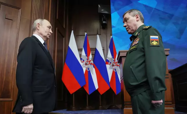 Russian Chief of General Staff Gen. Valery Gerasimov, right, reports to Russian President Vladimir Putin at the annual board meeting of the Russian Defense Ministry and award soldiers in Moscow, Wednesday, Dec. 17, 2025. (Alexander Kazakov/Sputnik, Kremlin Pool Photo via AP)