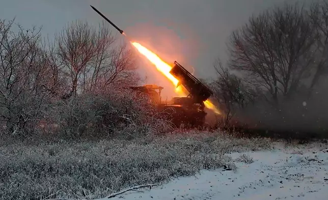In this image, made from video provided by Russian Defense Ministry Press Service on Tuesday, Dec. 16, 2025, a Russian "Grad" self-propelled multiple rocket launcher fires towards Ukrainian positions on an undisclosed location in Ukraine. (Russian Defense Ministry Press Service via AP)