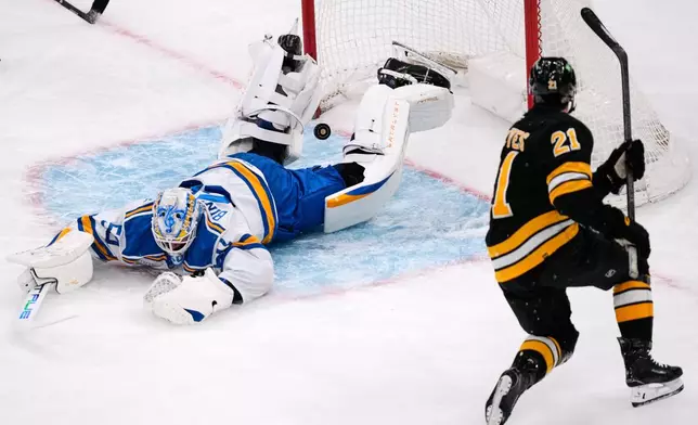 St. Louis Blues goaltender Jordan Binnington, left, drops to the ice after Boston Bruins center Alex Steeves (21) scored during the first period of an NHL hockey game, Thursday, Dec. 4, 2025, in Boston. (AP Photo/Charles Krupa)