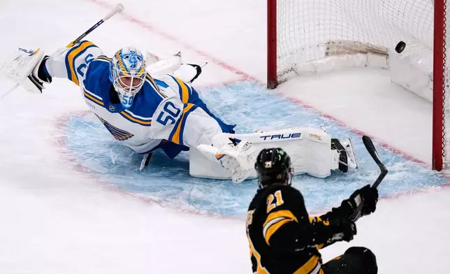 Boston Bruins center Alex Steeves (21) scores on St. Louis Blues goaltender Jordan Binnington during the first period of an NHL hockey game, Thursday, Dec. 4, 2025, in Boston. (AP Photo/Charles Krupa)