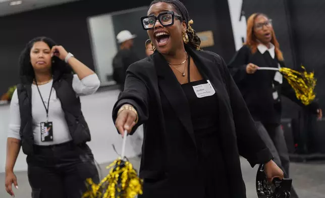 Members of the 2819 welcome team wave streamers and shake tambourines while singing popular Christian worship songs as guests enter 2819 Church on Nov. 16, 2025, in Atlanta. (AP Photo/Jessie Wardarski)