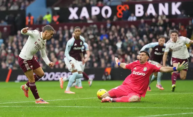 Arsenal's Leandro Trossard, left, makes an attempt to score during the English Premier League soccer match between Aston Villa and Arsenal in Birmingham, England, Saturday, Dec. 6, 2025. (AP Photo/Dave Shopland)