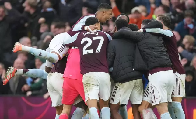 Aston Villa players celebrate after Aston Villa's Emiliano Buendia scored his side's second goal during the English Premier League soccer match between Aston Villa and Arsenal in Birmingham, England, Saturday, Dec. 6, 2025. (AP Photo/Dave Shopland)