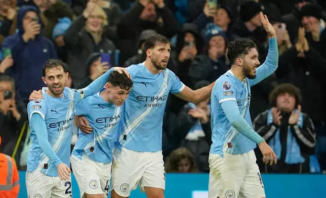 Manchester City's Phil Foden, second left, celebrates with teammates after scoring his side's third goal during the English Premier League soccer match between Manchester City and Sunderland in Manchester, England, Saturday, Dec. 6, 2025. (AP Photo/Dave Thompson)