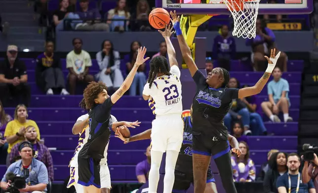 LSU guard Milaysia Fulwiley (23) passes the ball to a teammate between Texas-Arlington guard Jadyn Atchison (13) and forward Laura Bello (4) in the first half of an NCAA women's college basketball game between Texas-Arlington and LSU in Baton Rouge, La., Sunday, Dec. 21, 2025. (AP Photo/Peter Forest)