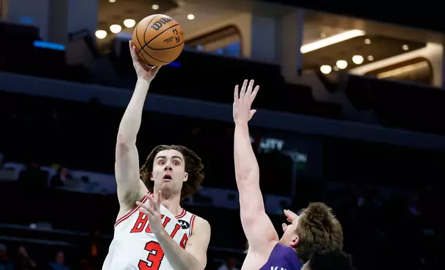 Chicago Bulls guard Josh Giddey (3) looks to shoot over Charlotte Hornets guard Kon Knueppel, right, during the first half of an NBA basketball game in Charlotte, N.C., Friday, Dec. 12, 2025. (AP Photo/Nell Redmond)