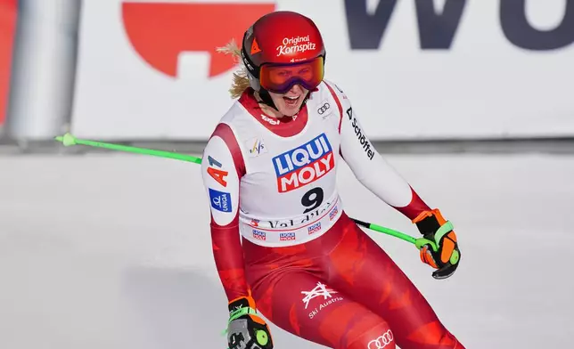 Austria's Cornelia Huetter celebrates at the finish area of an alpine ski, women's World Cup downhill, in Val D'Isere, France, Saturday, Dec. 20, 2025. (AP Photo/Pier Marco Tacca)