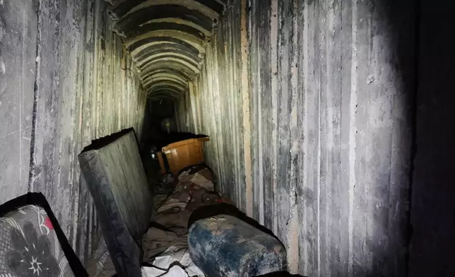Mattresses and a plastic chair lie on the floor inside a tunnel in Rafah, Gaza Strip, Monday, Dec. 8, 2025. (AP Photo/Sam Mednick)