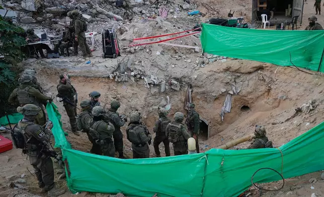 Israeli soldiers stand at the entrance of a tunnel where the army says the body of soldier Hadar Goldin was held in Rafah, Gaza Strip, Monday, Dec. 8, 2025. Hamas returned his remains to Israel as part of the current ceasefire. (AP Photo/Sam Mednick)