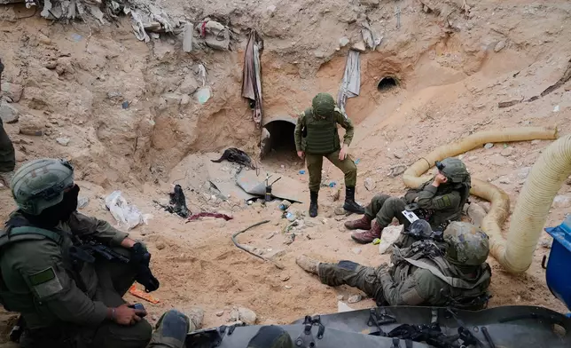 Israeli soldiers stand at the entrance of a tunnel where the army says the body of soldier Hadar Goldin was held in Rafah, Gaza Strip, Monday, Dec. 8, 2025. Hamas returned his remains to Israel as part of the current ceasefire. (AP Photo/Sam Mednick)