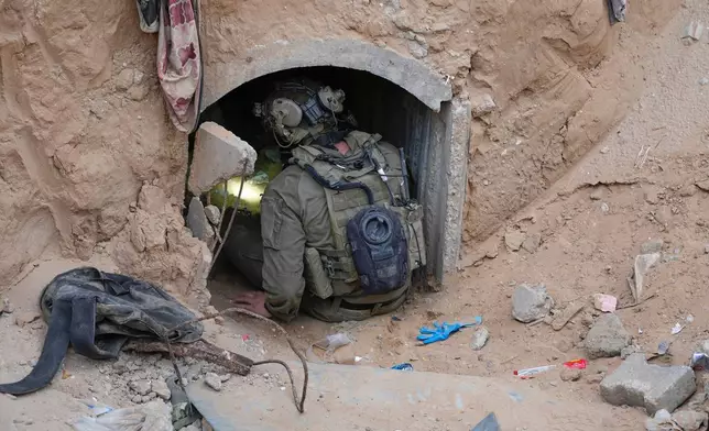 An Israeli soldier enters a tunnel where the army says the body of soldier Hadar Goldin was held in Rafah, Gaza Strip, Monday, Dec. 8, 2025. Hamas returned his remains to Israel as part of the current ceasefire. (AP Photo/Sam Mednick)