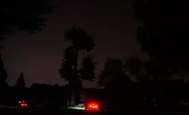 The taillights from a vehicle are shown as power outages darken the streets, in San Francisco, Saturday, Dec. 20, 2025. (AP Photo/Jeff Chiu)