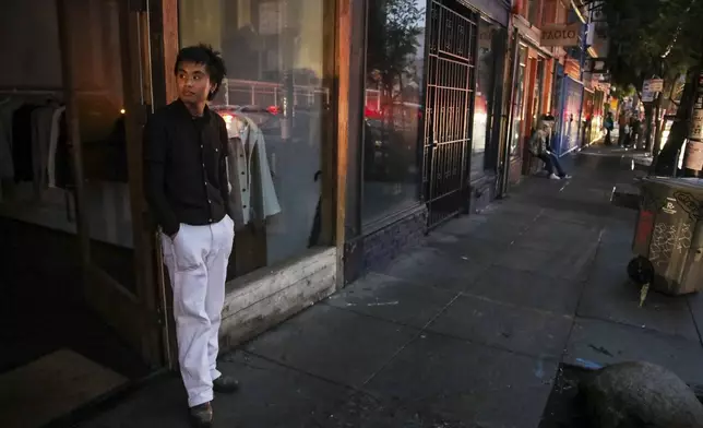 Ryan Sicat, store manager of Industry of All Nations, stands outside the store after a major power outage in San Francisco, Saturday, Dec. 20, 2025. (Yalonda M. James/San Francisco Chronicle via AP)