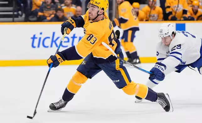 Nashville Predators defenseman Adam Wilsby (83) scores a goal past Toronto Maple Leafs left wing Matthew Knies (23) during the second period of an NHL hockey game Saturday, Dec. 20, 2025, in Nashville, Tenn. (AP Photo/George Walker IV)