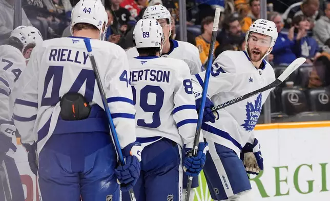 Toronto Maple Leafs center Nicolas Roy (55) celebrates his goal with teammates during the first period of an NHL hockey game against the Nashville Predators, Saturday, Dec. 20, 2025, in Nashville, Tenn. (AP Photo/George Walker IV)