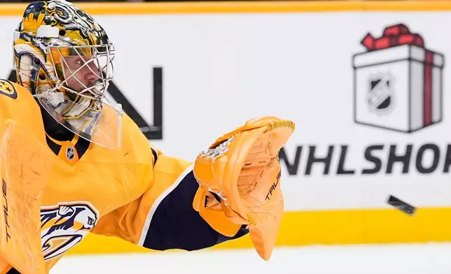 Nashville Predators goaltender Juuse Saros (74) catches a puck during the first period of an NHL hockey game against the Toronto Maple Leafs, Saturday, Dec. 20, 2025, in Nashville, Tenn. (AP Photo/George Walker IV)