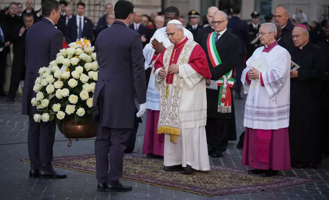 Pope Leo XIV arrives to pray in front of the statue of the Virgin Mary next to the Spanish Steps in Rome, Monday, Dec. 8, 2025, on the Catholic Feast of the Immaculate Conception. (AP Photo/Andrew Medichini)