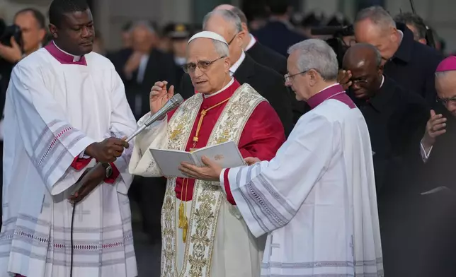 Pope Leo XIV leads the prayer in front of the statue of the Virgin Mary next to the Spanish Steps in Rome, Monday, Dec. 8, 2025, on the Catholic Feast of the Immaculate Conception. (AP Photo/Andrew Medichini)