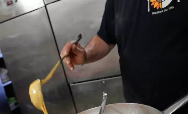 Italian cook Massimo Dante prepares a Carbonara at his restaurant in Rome, Wednesday, Dec. 10, 2025. (AP Photo/Gregorio Borgia)