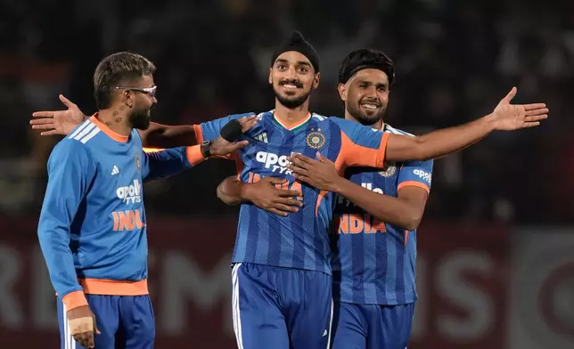India's Arshdeep Singh, center, celebrates with teammates the wicket of South Africa's Reeza Hendricks during the third T20 cricket match between India and South Africa in Dharamshala, India, Sunday, Dec. 14, 2025. (AP Photo/Ashwini Bhatia)
