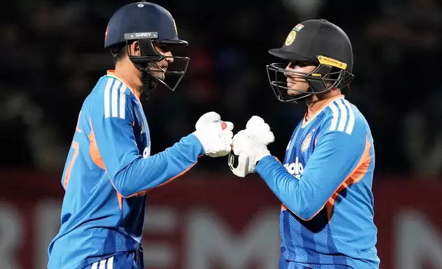 India's Shubman Gill, left, and Abhishek Sharma greets each other during the third T20 cricket match between India and South Africa in Dharamshala, India, Sunday, Dec. 14, 2025. (AP Photo/Ashwini Bhatia)