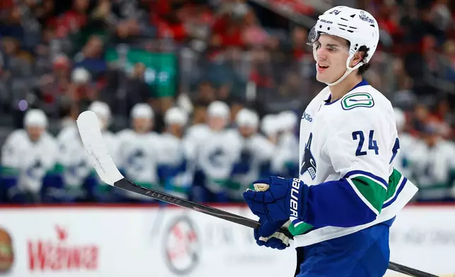 Vancouver Canucks defenseman Zeev Buium looks on after scoring during the first period of an NHL hockey game against the New Jersey Devils, Sunday, Dec 14, 2025, in Newark, N.J. (AP Photo/Noah K. Murray)