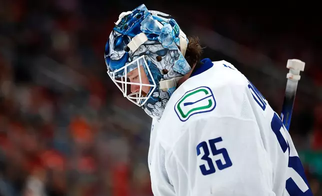 Vancouver Canucks goaltender Thatcher Demko looks on during the second period of an NHL hockey game against the New Jersey Devils, Sunday, Dec 14, 2025, in Newark, N.J. (AP Photo/Noah K. Murray)