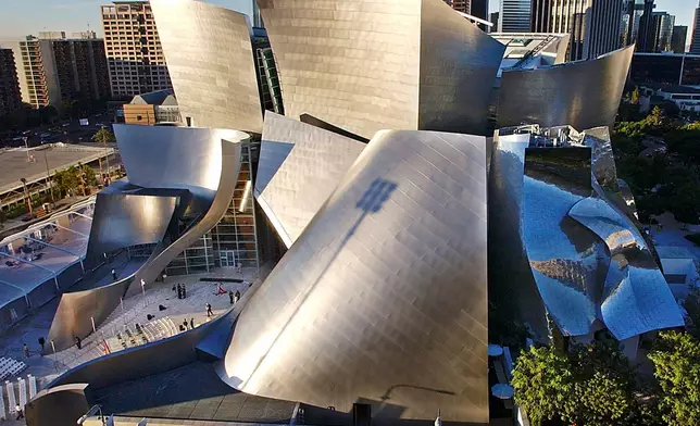 FILE - Early morning sun rays illuminate the Walt Disney Concert Hall designed by Frank Gehry, in downtown Los Angeles, Nov. 19, 2009. (AP Photo/Nick Ut, File)