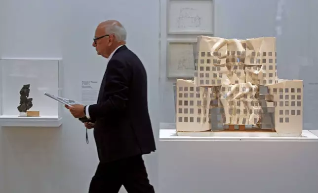 FILE - A model of Frank Gehry's Dr. Chau Chak Wing building, right, built in Sydney, Australia, is presented at the Pompidou Center in Paris, Oct. 6, 2014, as part of a retrospective on American-Canadian architect Frank Gehry. (AP Photo/Remy de la Mauviniere, File)