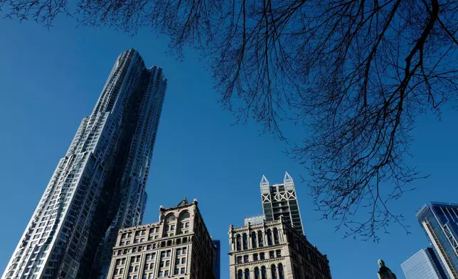 FILE - The Beckman Tower, left, designed by architect Frank Gehry towers over older architecture, in New York, March 5, 2018. (AP Photo/Mark Lennihan, File)