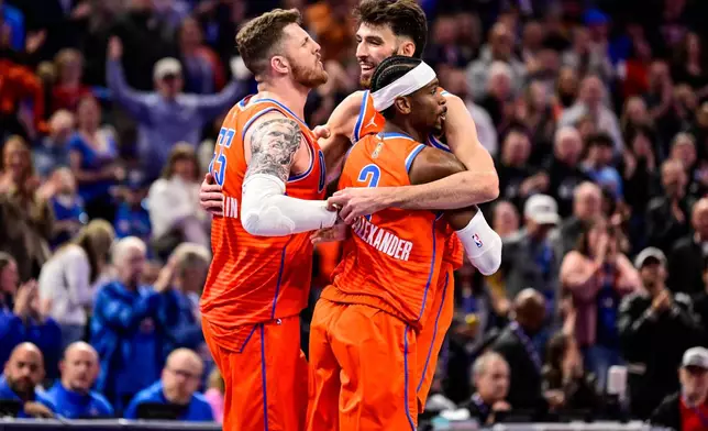 Oklahoma City Thunder center/forward Chet Holmgren (7), center, celebrates with Oklahoma City Thunder center/forward Isaiah Hartenstein (55) and Oklahoma City Thunder guard Shai Gilgeous-Alexander (2) during the second half of an Emirates NBA Cup basketball game, Wednesday, Nov. 26, 2025, in Oklahoma City. (AP Photo/Gerald Leong)