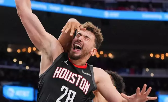 Houston Rockets center Alperen Sengun (28) is fouled by Los Angeles Clippers center Yanic Konan Niederhauser (14) during the first half of an NBA basketball game Tuesday, Dec. 23, 2025, in Inglewood, Calif. (AP Photo/Jae C. Hong)