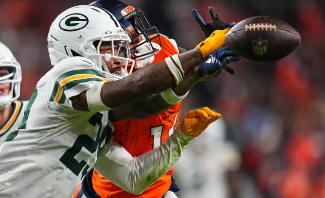 Green Bay Packers' Xavier McKinney breaks up a pass intended for Denver Broncos' Courtland Sutton during the second half of an NFL football game Sunday, Dec. 14, 2025, in Denver. (AP Photo/Jack Dempsey)