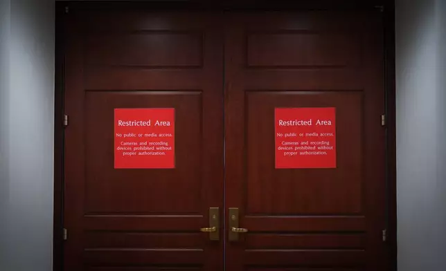 The closed entrance to a secure room is seen where Navy Adm. Frank "Mitch" Bradley, commander of the U.S. Special Operations Command, is expected to brief top congressional lawmakers overseeing national security as they investigate how Defense Secretary Pete Hegseth handled a military strike on a suspected drug smuggling boat and its crew in the Caribbean near Venezuela Sept. 2, at the Capitol in Washington, Thursday, Dec. 4, 2025. (AP Photo/J. Scott Applewhite)