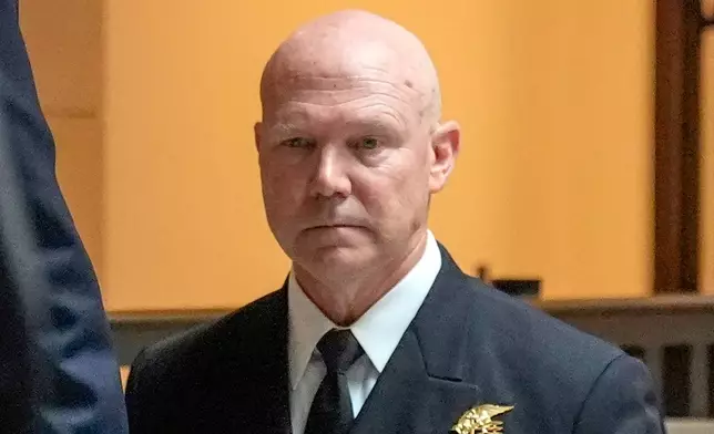U.S. Navy Adm. Frank M. Bradley walks to a meeting with senators on Capitol Hill, Thursday, Dec. 4, 2025, in Washington. (AP Photo/Mark Schiefelbein)