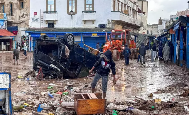 People inspect the damage caused by flash floods in Safi, Morocco, Monday, Dec. 15, 2025. (AP Photo/Abderrazak Gouach)