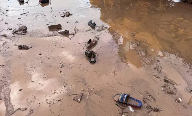 Shoes are left amidst the damage caused by flash floods in Safi, Morocco, Monday, Dec. 15, 2025. (AP Photo/Abderrazak Gouach)