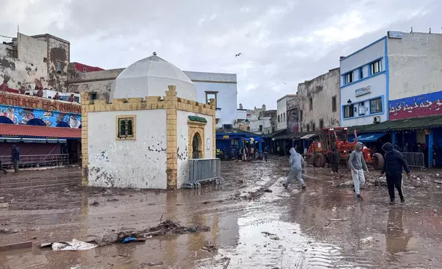 People inspect the damage caused by flash floods in Safi, Morocco, Monday, Dec. 15, 2025. (AP Photo/Abderrazak Gouach)