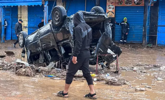 People inspect the damage caused by flash floods in Safi, Morocco, Monday, Dec. 15, 2025. (AP Photo/Abderrazak Gouach)