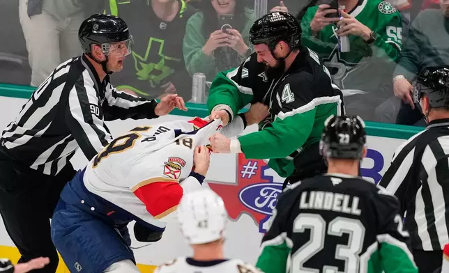 Dallas Stars left wing Jamie Benn (14) delivers a punch to Florida Panthers' Noah Gregor (18) as the two fight in the second period of an NHL hockey game in Dallas, Saturday, Dec. 13, 2025. (AP Photo/Tony Gutierrez)