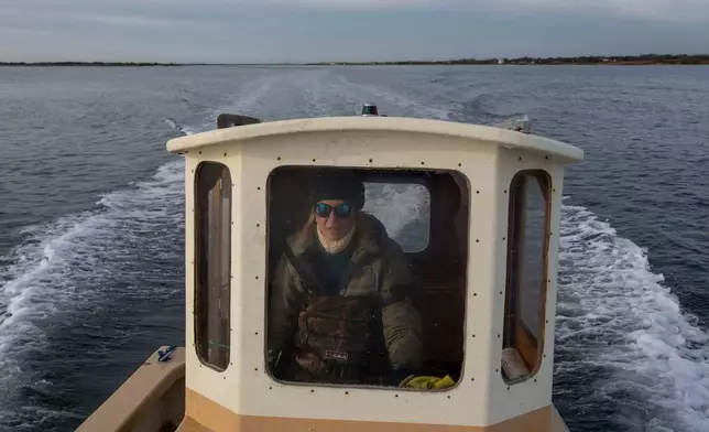 Retired WNBA star and Hall of Famer Sue Wicks rides her boat to check on her oysters in Moriches Bay in New York, Thursday, Nov. 20, 2025. (AP Photo/Yuki Iwamura)