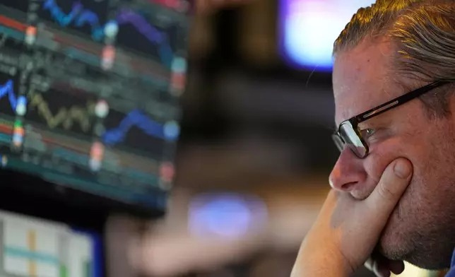 Gregg Maloney works on the floor at the New York Stock Exchange in New York, Wednesday, Dec. 10, 2025. (AP Photo/Seth Wenig)