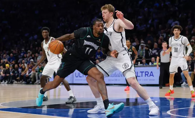Minnesota Timberwolves center Naz Reid (11) drives to the basket while Brooklyn Nets forward Danny Wolf defends during the first half of an NBA basketball game, Saturday, Dec. 27, 2025, in Minneapolis. (AP Photo/Bailey Hillesheim)
