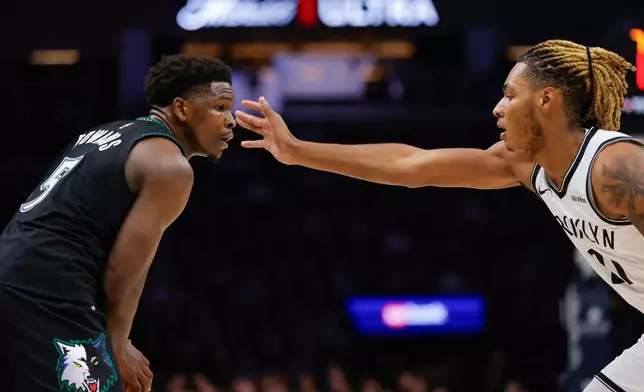Minnesota Timberwolves guard Anthony Edwards (5) handles the ball while Brooklyn Nets forward Noah Clowney defends during the first half of an NBA basketball game, Saturday, Dec. 27, 2025, in Minneapolis. (AP Photo/Bailey Hillesheim)