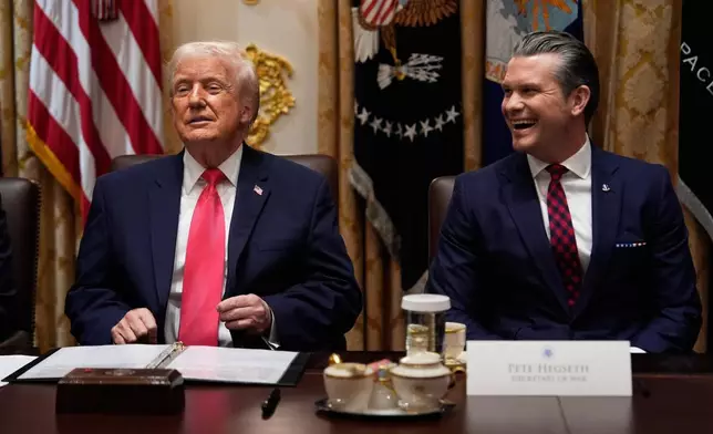 President Donald Trump speaks during a Cabinet meeting at the White House, Tuesday, Dec. 2, 2025, in Washington, as Defense Secretary Pete Hegseth looks on. (AP Photo/Julia Demaree Nikhinson)
