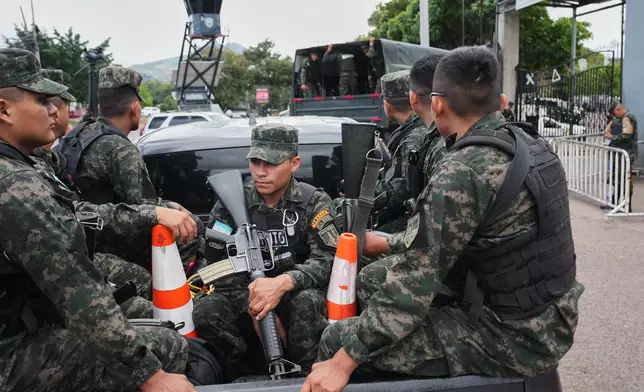 Soldiers transport ballots to an electoral facility in Tegucigalpa, Honduras, Monday, Dec. 1, 2025. (AP Photo/Moises Castillo)