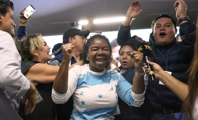 Supporters of presidential candidate Nasry Asfura, of the National Party, celebrate preliminary results during general election in Tegucigalpa, Honduras, Sunday, Nov. 30, 2025. (AP Photo/Emmanuel Andres)