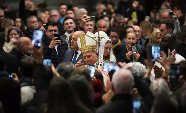Pope Leo XIV arrives to celebrate a Mass on the occasion of the Jubilee of Prisoners in St. Peter's Basilica, at the Vatican, Sunday, Dec. 14, 2025. (AP Photo/Alessandra Tarantino)