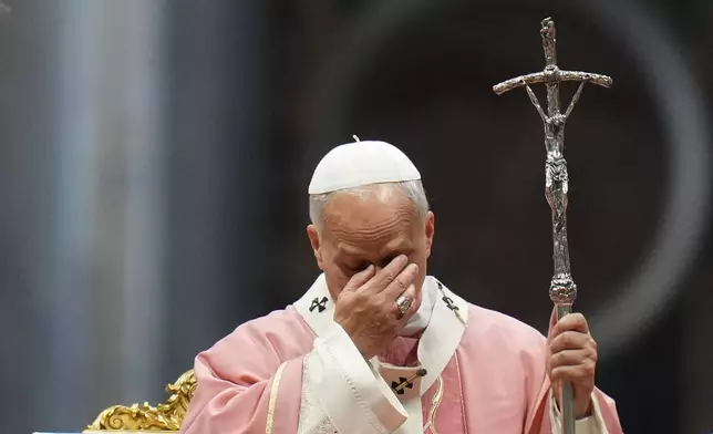 Pope Leo XIV gestures as he celebrates a Mass on the occasion of the Jubilee of Prisoners in St. Peter's Basilica, at the Vatican, Sunday, Dec. 14, 2025. (AP Photo/Alessandra Tarantino)